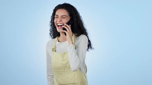 Woman, laugh and phone call in studio for conversation, communication or gossip on blue background