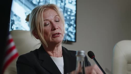 Woman Speaking at Corporate Conference Table Indoors