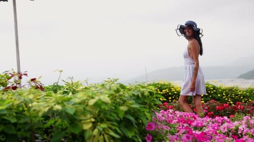 A Woman's Serene Stroll In A Flower Farm