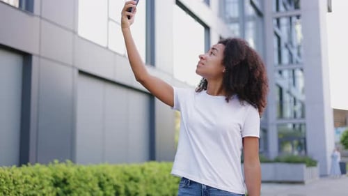 Woman Uses Phone in the City