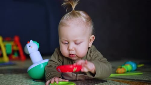 Cute Baby Playing with Colorful Toys on Mat