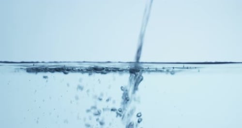 Water Stream Pouring Into Clear Still Pool