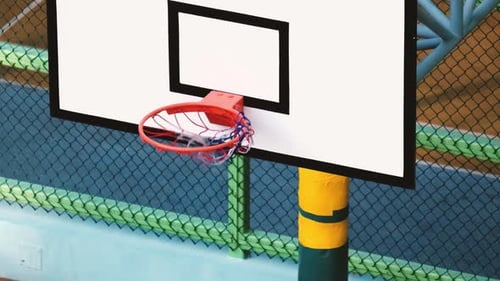 Basketball Goes Through Hoop on Outdoor Court