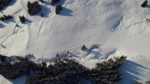 Top View Of Tourists Skiing In Saalbach-Hinterglemm Resort Town, Austria. Aerial Descending Shot