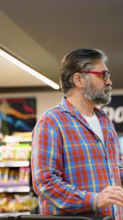 Senior Man Selecting Discounted Cheese at Grocery Store