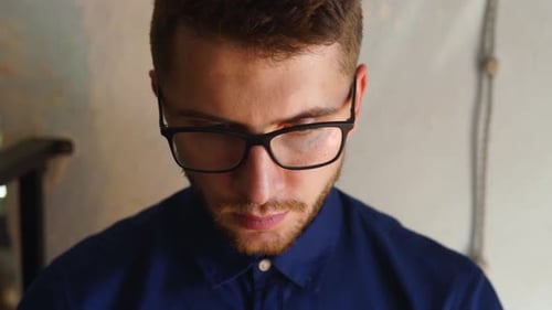 Close Up of Man with Glasses Looking Down
