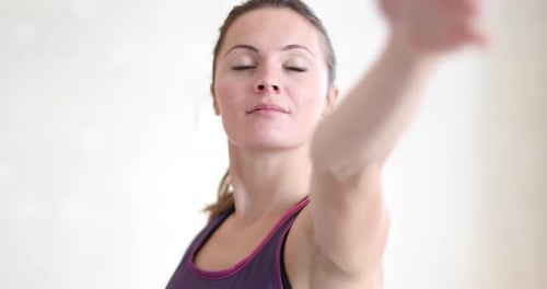 Woman Practicing Yoga Poses Indoors for Health and Fitness