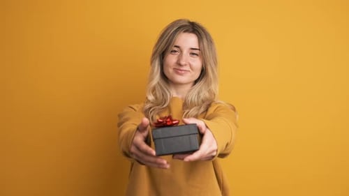 Smiling Woman Presents a Birthday Gift