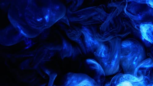 Abstract Blue Glitter Liquid Swirls in the Dark