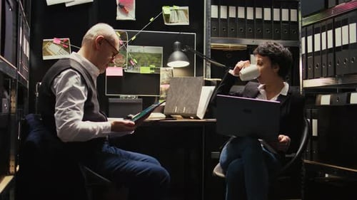 Man and Woman Working with Technology at Desk
