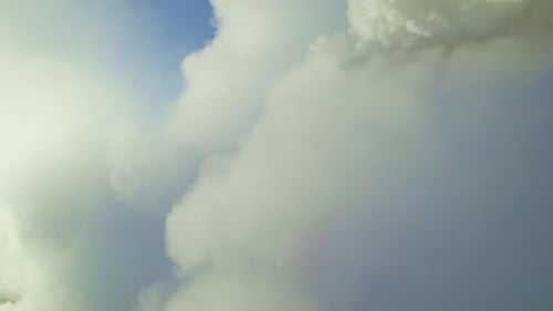 Vapor Cloud Rises Over Mountainous Terrain During Early Morning Daylight in Serene Landscape