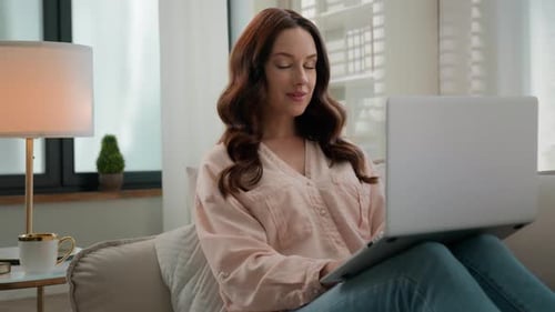 Woman Using Laptop Computer at Home