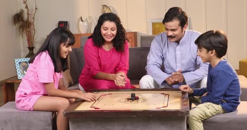 Family Plays Carrom Board Game in Living Room