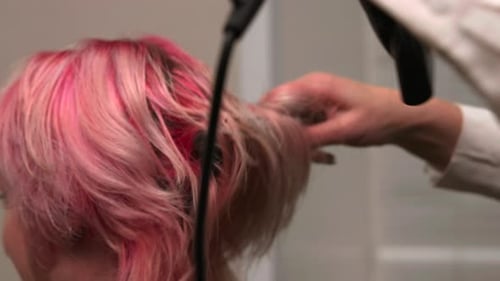 Stylist Dries Woman's Dyed Hair in Hair Salon