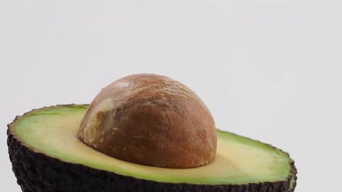 Rotating avocados on a white background.