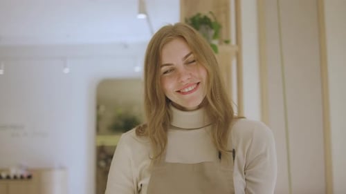 Smiling Woman Holding Tray with Two Mugs Indoors