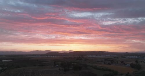 Vibrant Sunrise Over Rolling Hills Landscape
