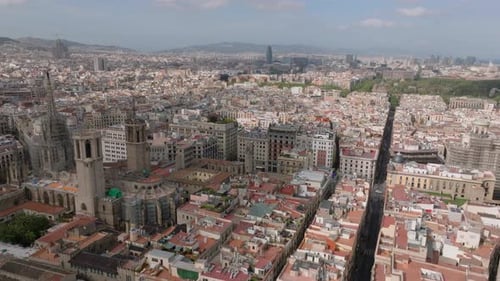 Aerial Cinematic Shot of Urban Borough Around Cathedral of Barcelona Cityscape with Famous La