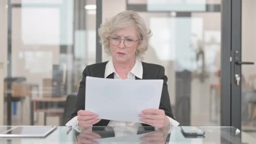 Woman Reading Document in Office Coughs