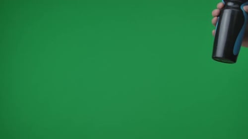 In Frame on Green Background Chromakey Male Hand That Holds Holds Out a Plastic Black and Blue