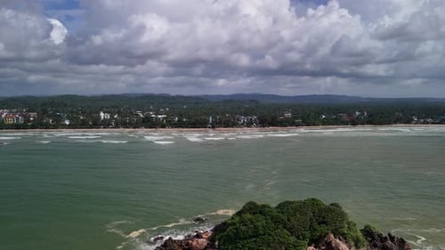 Weligama Bay Sri Lanka, aerial drone above Ramya Rock, village rainforest skyline