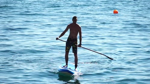 Man Sup Sea Strong Athletic Man Learns to Paddle Sup Standing on Board in Open Sea Ocean on Sunny