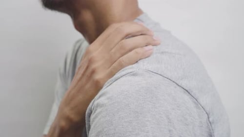 Man Rubbing Shoulder in Pain, Close Up