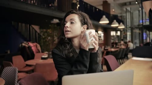 Caucasian Woman Sitting Inside of Cafe