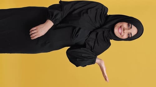 Smiling Woman in Dress with Hand Gesture