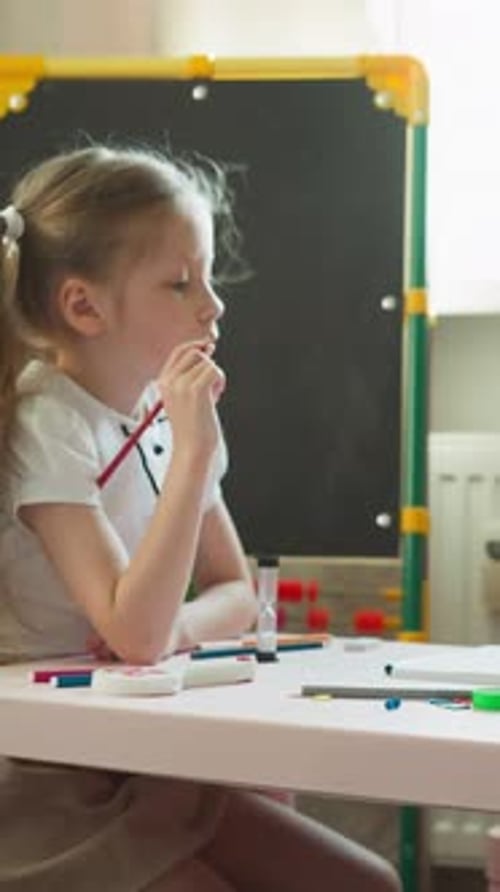 Child Learning and Drawing at Desk Indoors