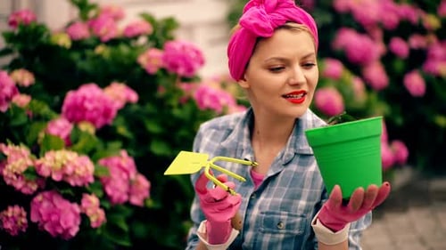 Woman Gardening with Pink Flowers in the Background