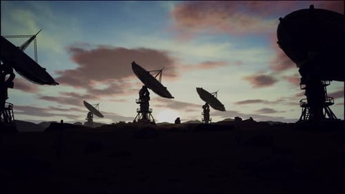 Satellite Dishes On Field Against Cloudy Sky During Sunset