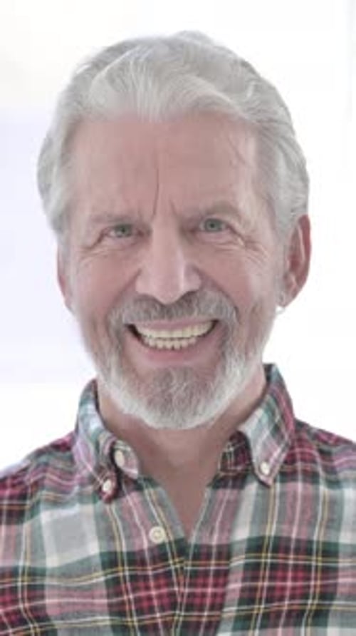 Senior Man Smiling Confidently with Gray Hair Indoors