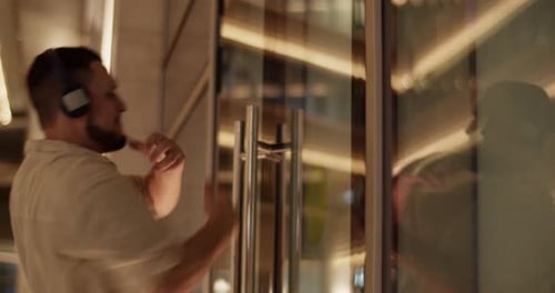 Man Dancing at Night with Headphones On