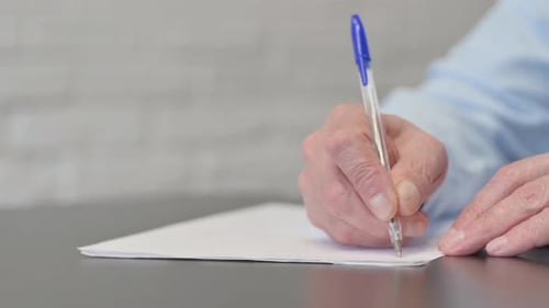 Close up of Old Businessman Writing a Letter