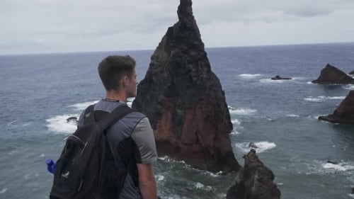 Man stands in front of famous rock formation at Ponta de Sao Lourenco; Madeira