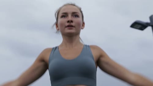 Young Woman Exercising Doing Jumping Jacks