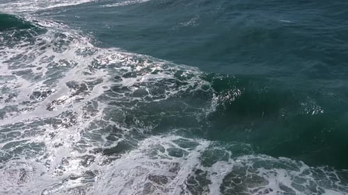 Crawling Sea Waves Over Foamy White Surface. Aerial Drone Shot
