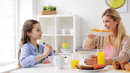 Woman and Child Enjoy Breakfast at Table