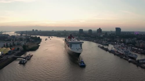 Massive Cruise Ship Departing City Harbor at Sunset Aerial Waterway View