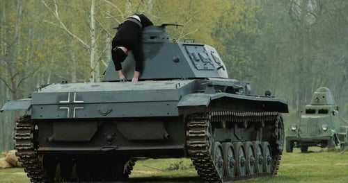 Nach der Schlacht liegt Reenactor als tot verkleidet deutsche Panzerbesatzung auf einem leichten Panzer der deutschen Wehrmacht getötet