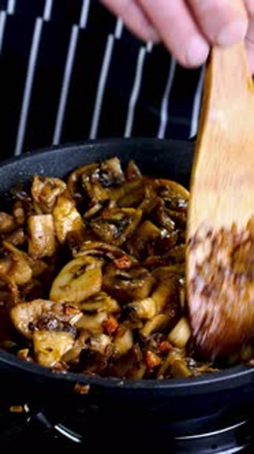 Succulent Champignons Sizzle and Caramelize in Hot Skillet Stir with Onion