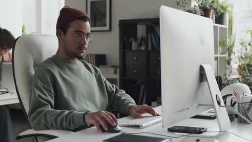 Developer Working on Computer at his Workplace
