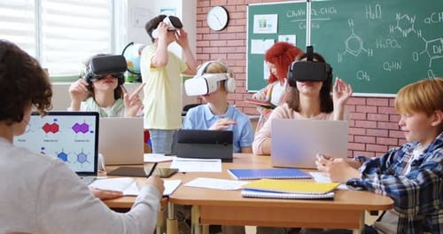 Caucasian Happy Kids in VR Headsets Having Virtual Reality Play in Classroom Interactive Studying