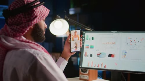 Man Holding Phone in Virtual Office Meeting