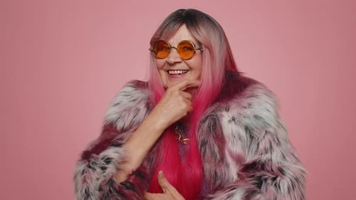 Stylish Senior Woman Smiling with Fur Coat and Sunglasses