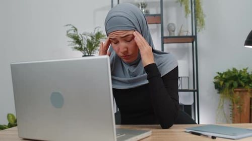 Woman Working on Laptop in Home Office
