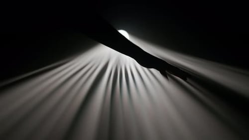 Heller, warmer Strahler, professionelle Beleuchtung, leuchtet in der Dunkelheit, Hand, Silhouette, berührend