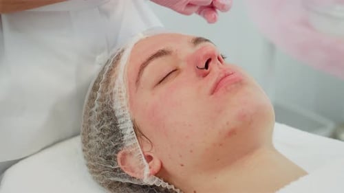 Cleaning Skin in Modern Clinic Performed By Cosmetologist Using Soft Wipes Woman Lying Relaxed As