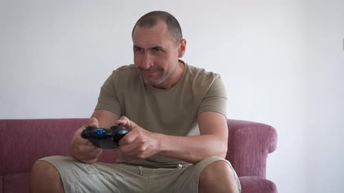 Man Enthusiastically Playing Video Game on Couch